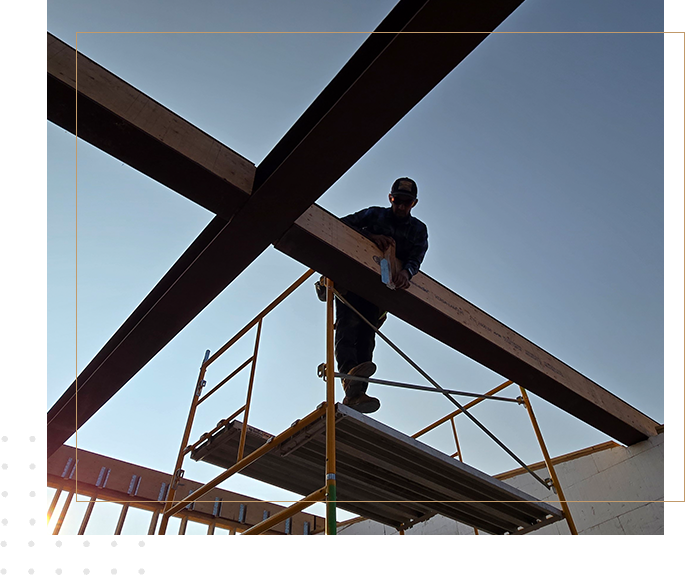 A man standing on top of a metal structure.