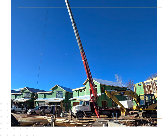 A crane is in the foreground of a construction site.