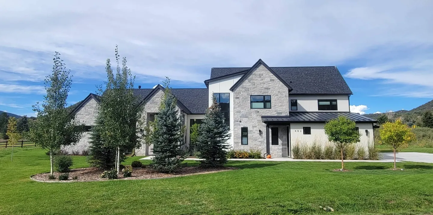 A large house with a lawn in front of it